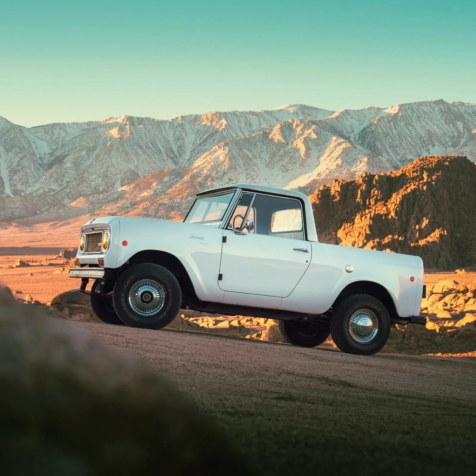 A family with their pickup truck in the mountains